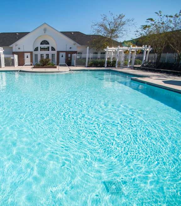 A large swimming pool in front of a building.