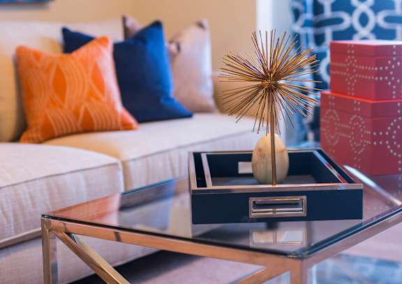 A glass table with a decorative item on it.