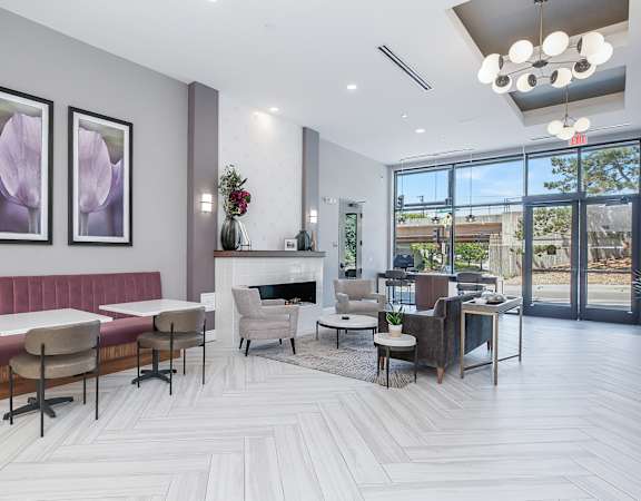 a seating area with couches chairs and tables