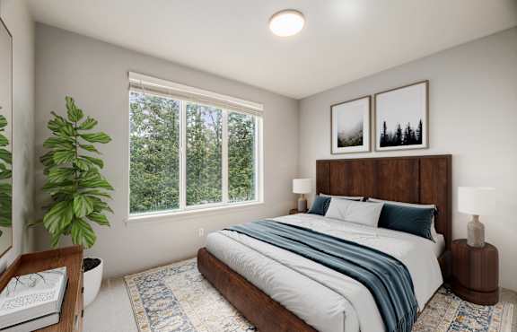 A bedroom with a large bed and a window overlooking a forest.