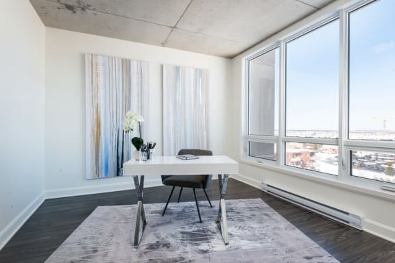an office with a white desk and a window