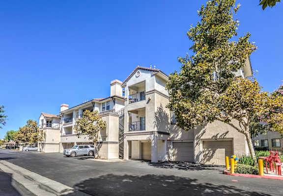 a street view of an apartment building with a car parked in front