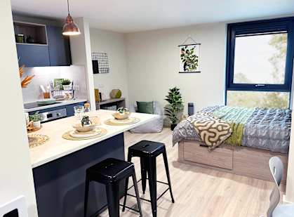 a bedroom and a kitchen in a small apartment