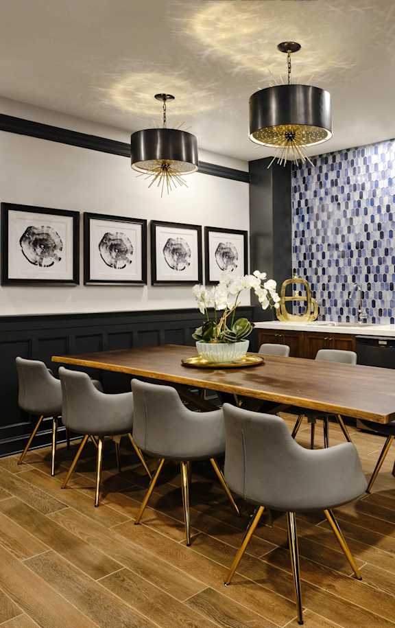 A dining room with a wooden table and grey chairs.