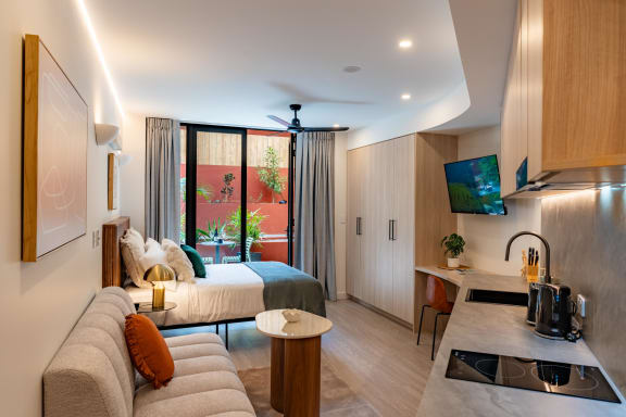 a room with a bed and a couch in a hotel room