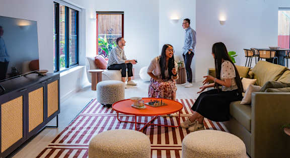 a group of people sitting in a living room