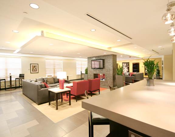a large kitchen with a long island with chairs and a dining table