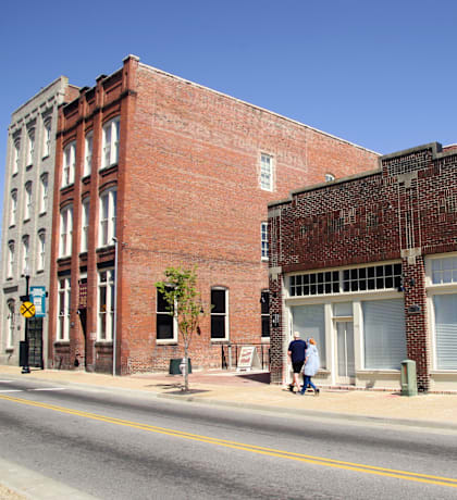 an old brick building on the corner of a city street
