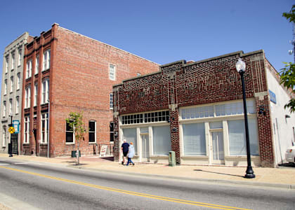 an old brick building on the corner of a city street