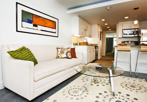 a living room with a white couch and a glass coffee table  at The Palms on Main in Columbia, 29201