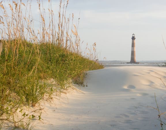 a view of the lighthouse from the beach