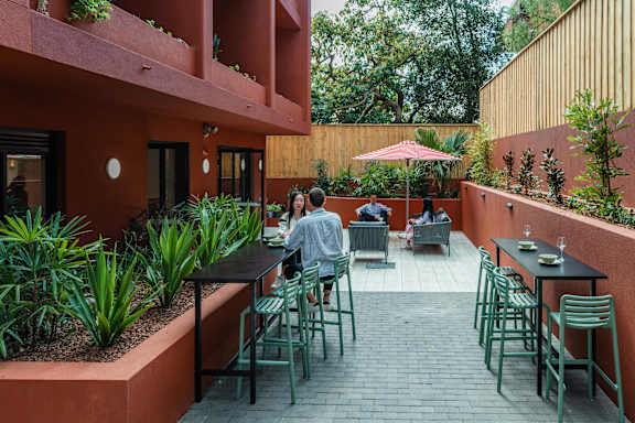 a man sitting at a table in an outdoor patio