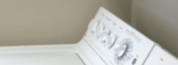 a pile of towels sitting next to a washing machine