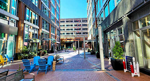 A sunny day in a courtyard surrounded by buildings.