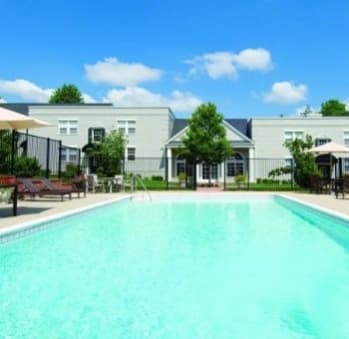a large pool with a building in the background at Myerton Apartments, VA