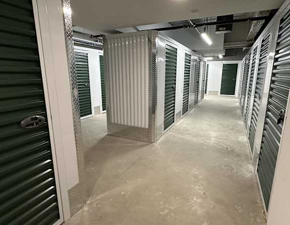 a view of a hallway in a data center with metal partitions