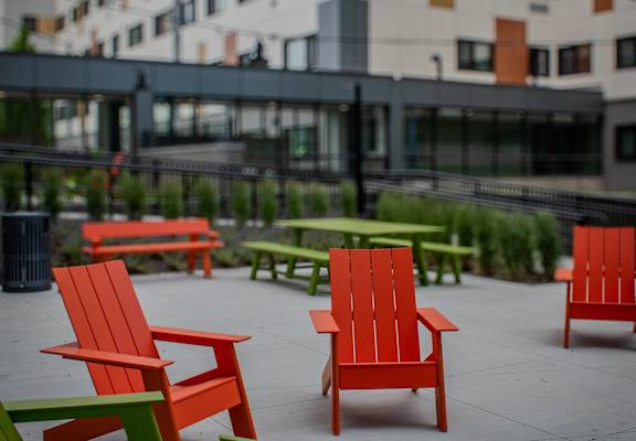 a group of red and green chairs sitting on a patio