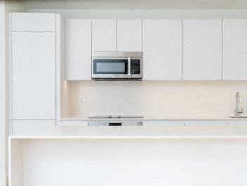 A microwave is on top of a stove.