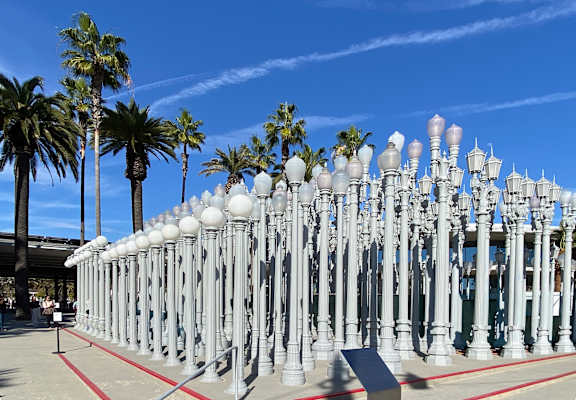 A row of white street lamps are lined up in a row.