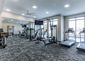 Thumbnail 3 of 31 - A spacious gym with treadmills, exercise bikes, and other equipment.at Tiffany Flats, Columbus, Ohio