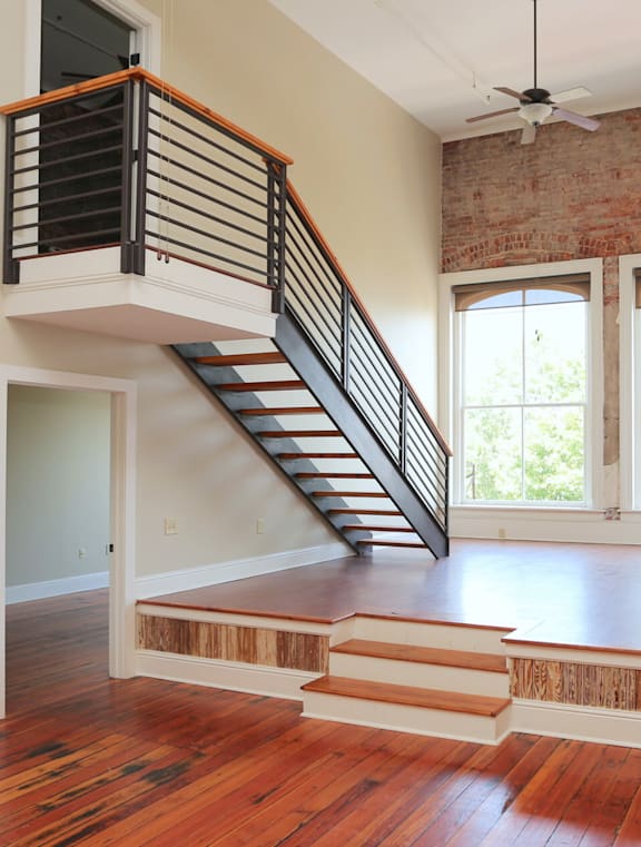 A room with a staircase and a window.