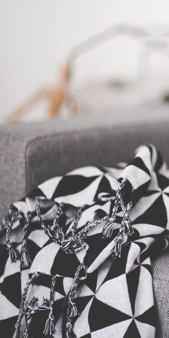 a pile of papers and a newspaper on a couch