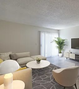 A living room with a white sofa, a white coffee table, and a television.
