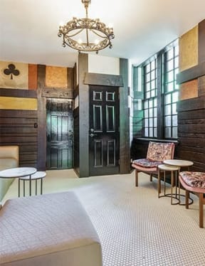 a room with a bed chairs and a chandelier at 1033 W Loyola, Illinois