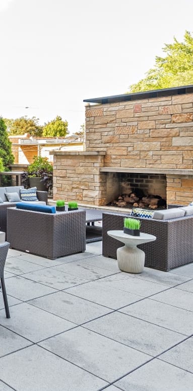 A patio with a fireplace and seating area.