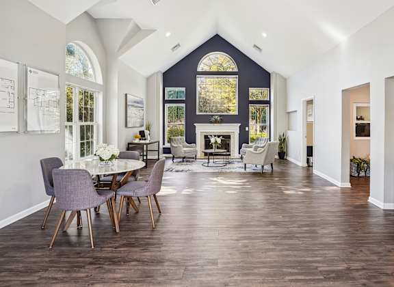 A modern dining room with a large table and chairs.