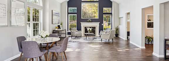 A modern dining room with a large table and chairs.