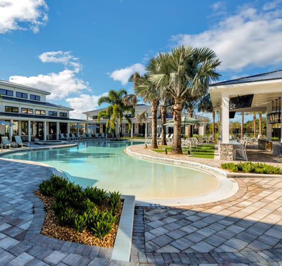 the pool is surrounded by palm trees and plants at Drift, Daytona Beach, FL, 32117