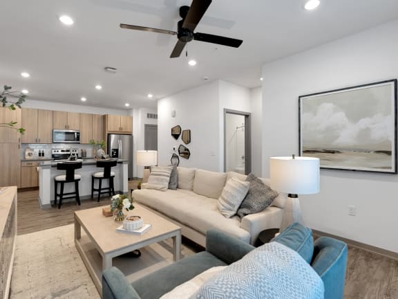 a living room with a couch and a ceiling fan at Drift, Daytona Beach, FL, 32117