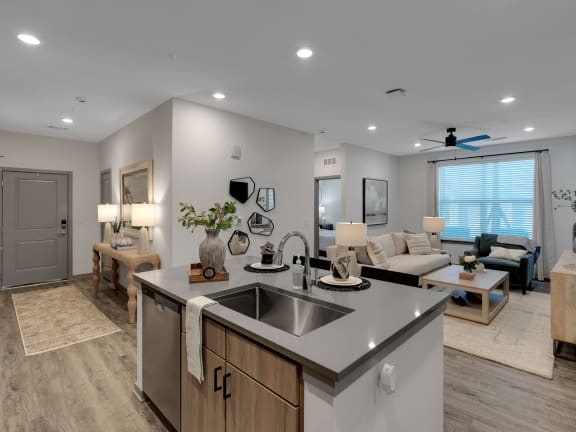 an open living room and kitchen with a living room with a couch and a table at Drift, Daytona Beach, FL, 32117