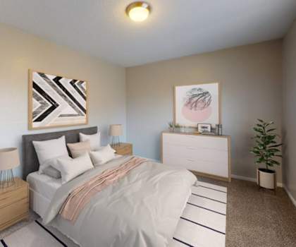 A bedroom with a bed, two nightstands, a dresser, and two lamps.