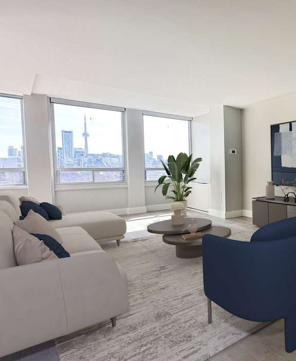 an empty living room with windows and a view of the city