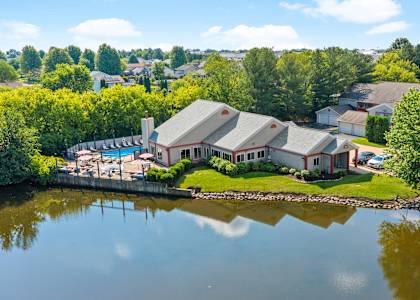 an aerial view of a house next to a lake