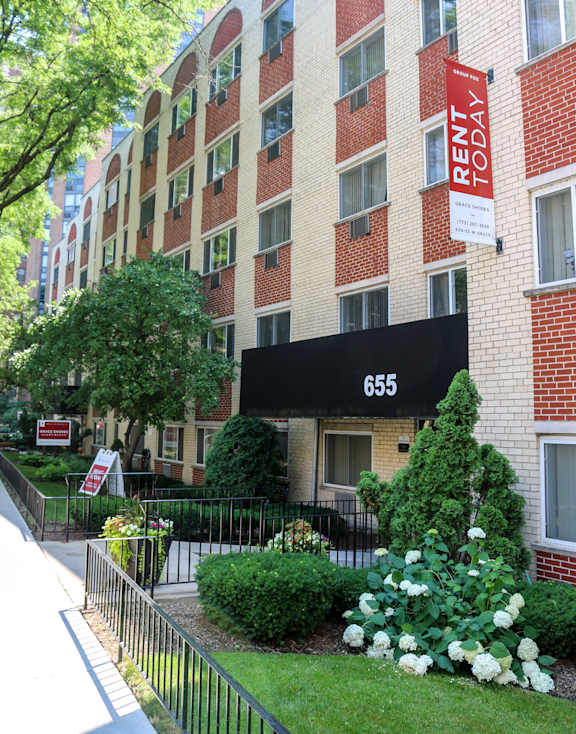 A red brick building with a sign that says "Rent Today".