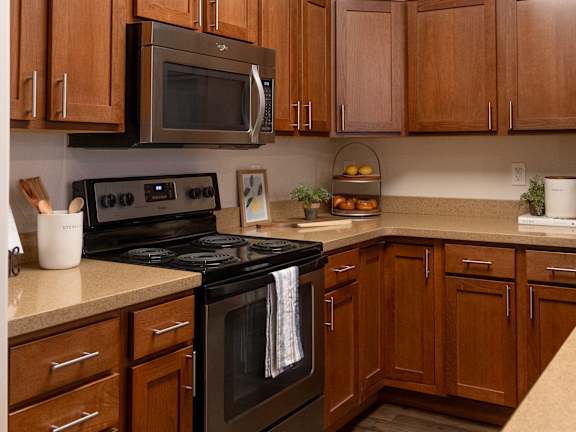 Kitchen with Stainless Steel Appliances at Four Seasons Apartments & Townhomes