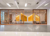 Thumbnail 6 of 24 - A room with a white floor and a wooden partition with a geometric pattern.