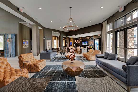 a lobby with couches and chairs and a table at Watermark at Harvest Junction, Colorado