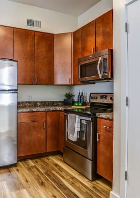 a kitchen with stainless steel appliances and wooden cabinets
