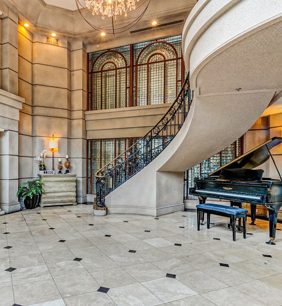 a grand piano sits in the center of the lobby