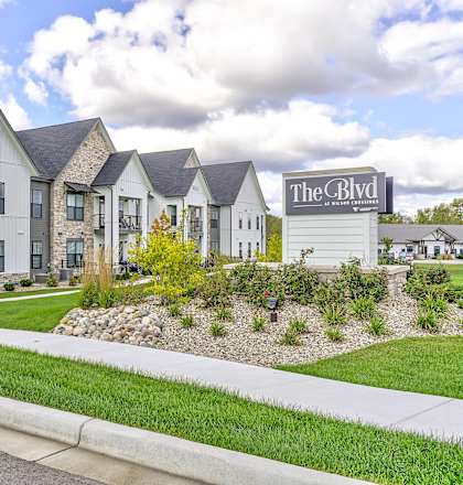 The Clyde apartments are located in a grassy area with a sidewalk.