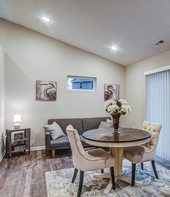 a living room with a couch and a table with chairs
