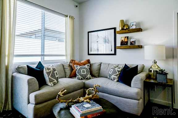 a living room with a couch and pillows and a coffee table