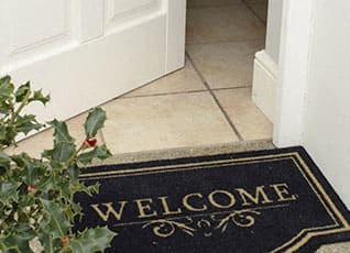 a welcome mat in front of a door