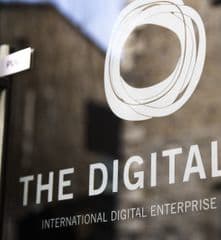 a sign for the digital hub in front of a building