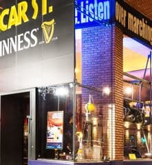 a store front of a bar with a glass window