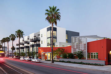 a rendering of a city street with buildings and palm trees